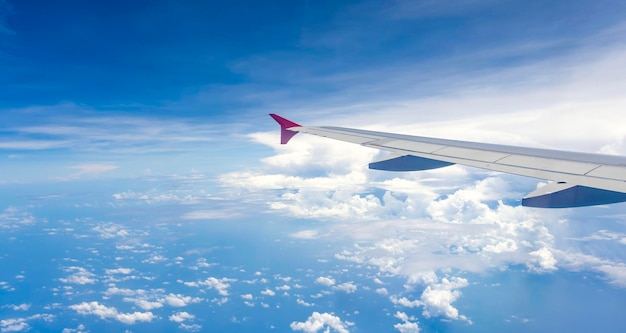 Aircraft wings fly on clouds sky