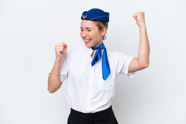 Airplane blonde stewardess woman isolated on white background celebrating a victory