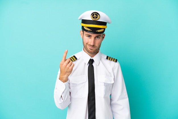 Airplane caucasian pilot isolated on blue background pointing with the index finger a great idea