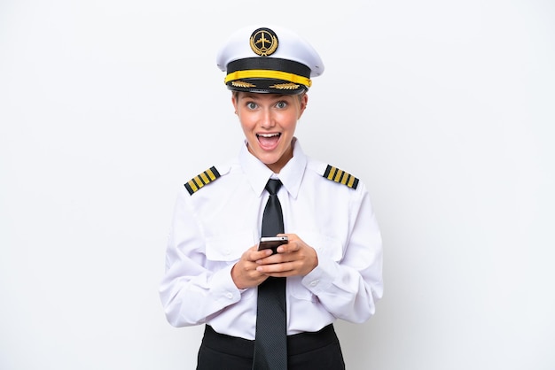 Airplane caucasian pilot woman isolated on white background surprised and sending a message