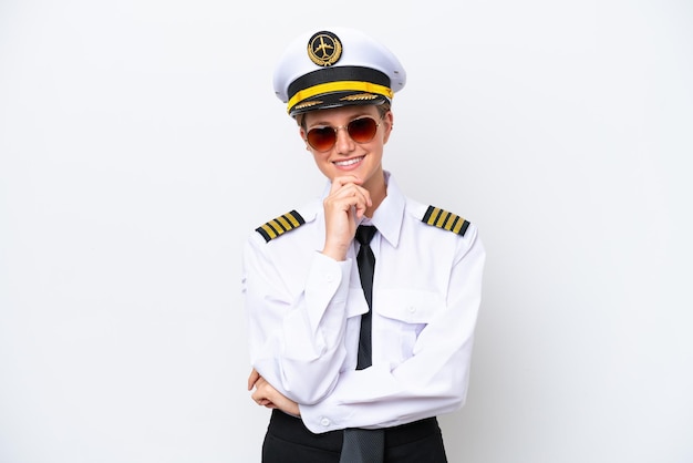 Airplane caucasian pilot woman isolated on white background with glasses and smiling