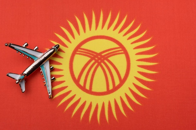 Airplane over the flag of Kyrgyzstan the concept of travel