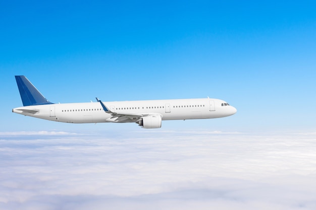 Airplane flies above the clouds high in the sky.