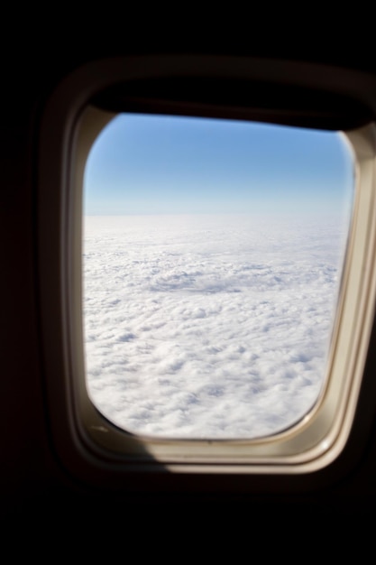 Airplane flight wing of an airplane flying above the clouds