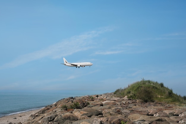 Airplane flying in blue sky over sea Space for text