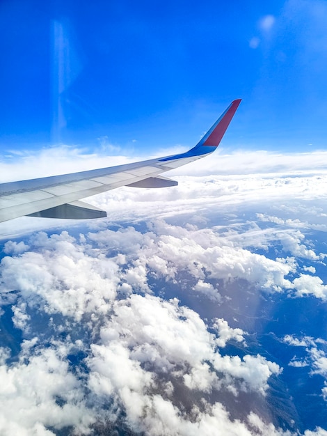 Airplane flying above the clouds wing in the sky