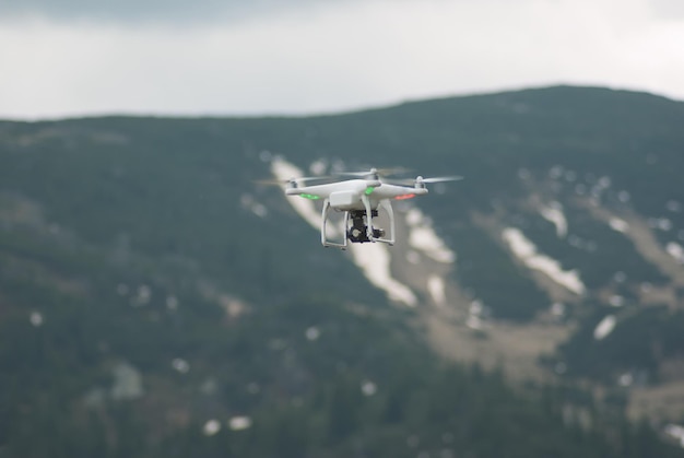 Airplane flying over mountain against sky