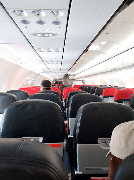 Airplane interior, luggage rack and ventilation control buttons.