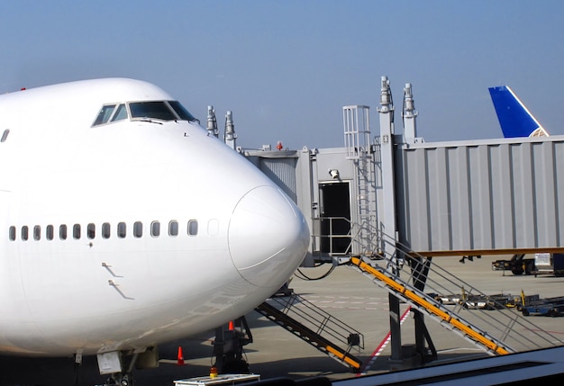 An airplane and a jet bridge at the airport