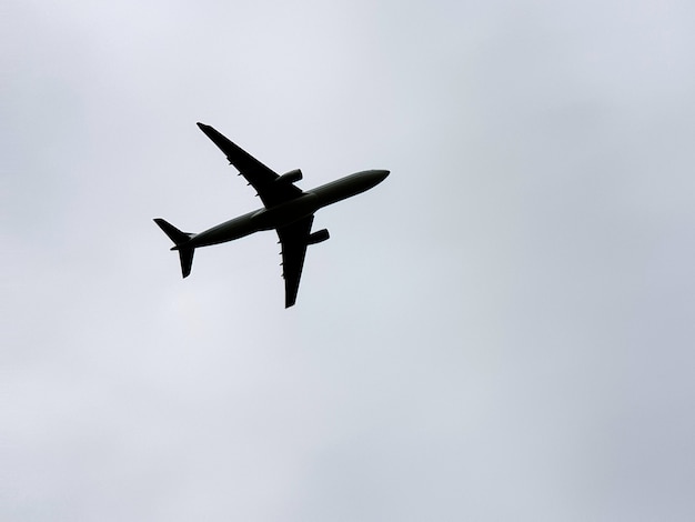 Airplane in the overcast sky background