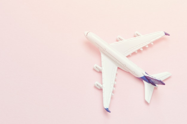 Airplane on a pink background. Place for text. Close-up