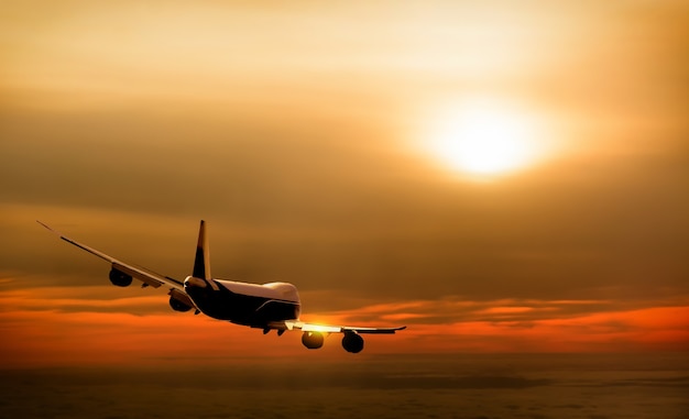 Airplane in the sky at sunset background