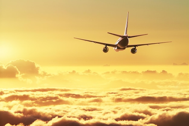 Airplane in the sky at sunset