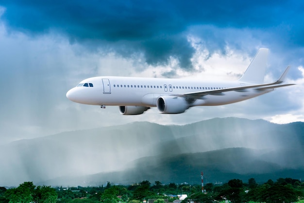 Airplane in the sky with rain over mountain The plane flies in terrible thunderstormConcept of climate weather