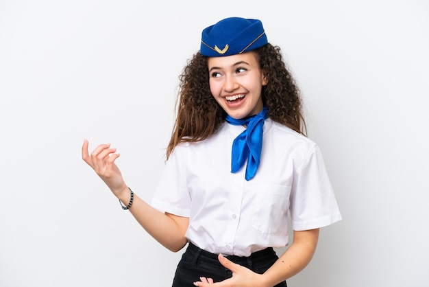 Airplane stewardess Arab woman isolated on white background making guitar gesture