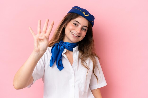 Airplane stewardess caucasian woman isolated on pink background happy and counting four with fingers