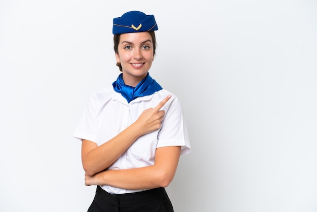 Airplane stewardess caucasian woman isolated on white background pointing to the side to present a product