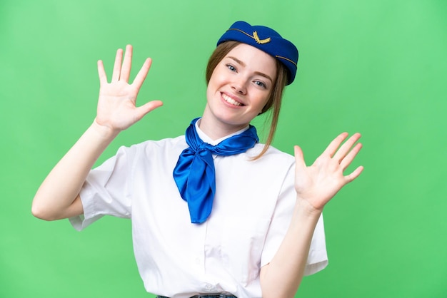 Airplane stewardess over isolated chroma key background counting ten with fingers