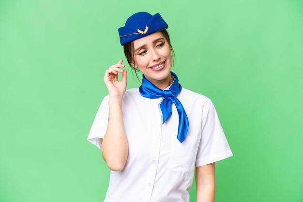 Airplane stewardess over isolated chroma key background thinking an idea