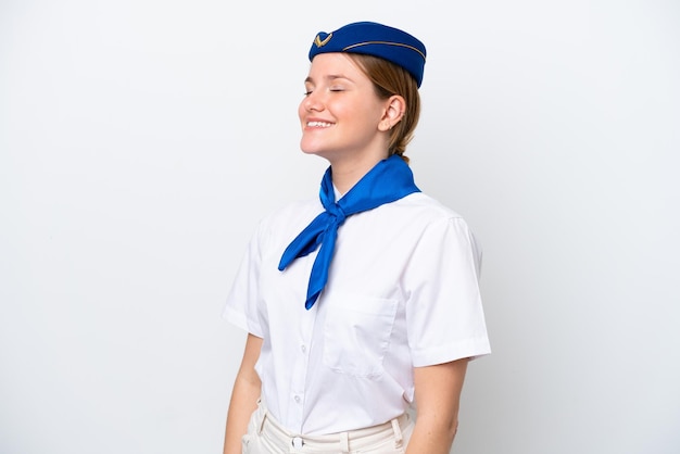 Airplane stewardess woman isolated on white background laughing in lateral position