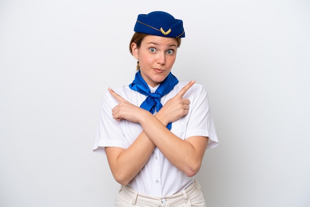 Airplane stewardess woman isolated on white background pointing to the laterals having doubts