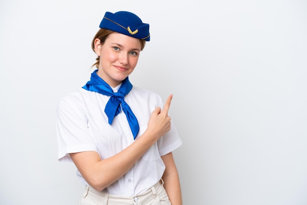 Airplane stewardess woman isolated on white background pointing to the side to present a product