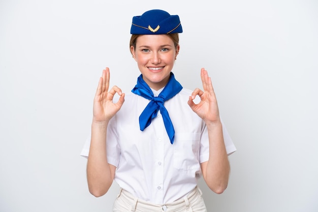 Airplane stewardess woman isolated on white background showing an ok sign with fingers