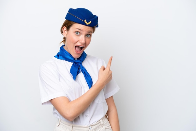 Airplane stewardess woman isolated on white background surprised and pointing side