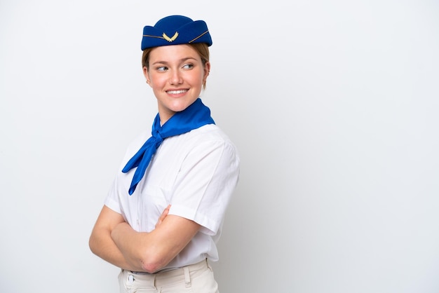 Airplane stewardess woman isolated on white background with arms crossed and happy