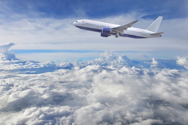 Airplane take off on the blue sky and clouds background