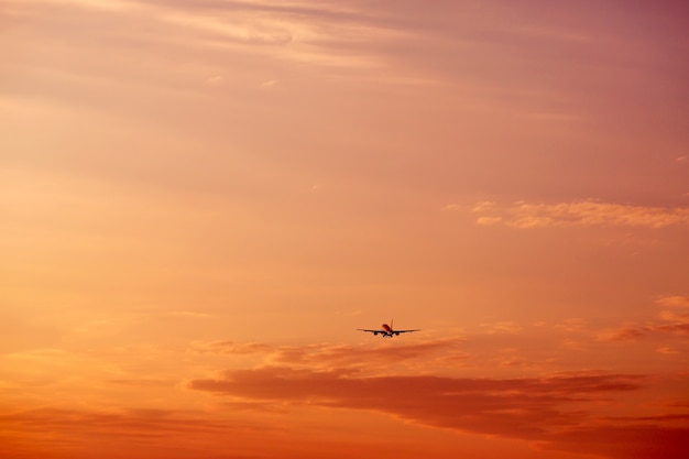 Airplane taking off and flying high in sunset sky vacation concept