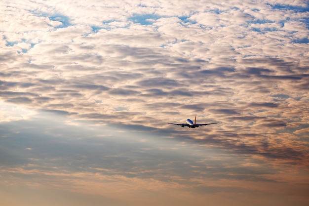 Airplane taking off at the sunset sky silhouette of aircraft in the sky