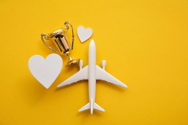 Airplane travel awards. Aviation business satisfaction. Toy airplane with gold trophy.