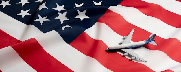 A airplane on the usa flag as a symbol of passenger transportation