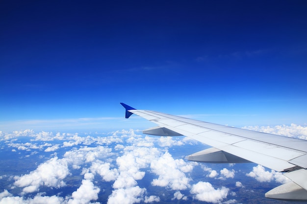 Airplane wing See clouds in the dark sky.