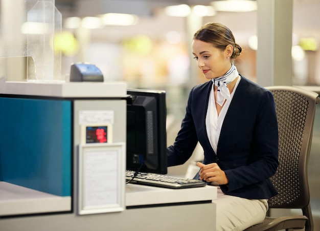 Airport check in desk and woman on computer for security travel agent or transport management Airplane concierge customer service and ticket help of global booking journey or flight receptionist