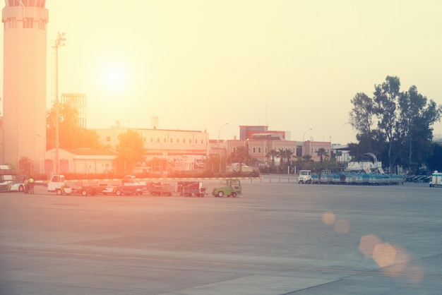 Airport with service cars at sunset