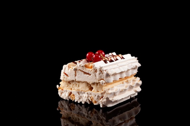 Airy cake with cream and berries Piece of cake Sweet meringue dessert Dark background