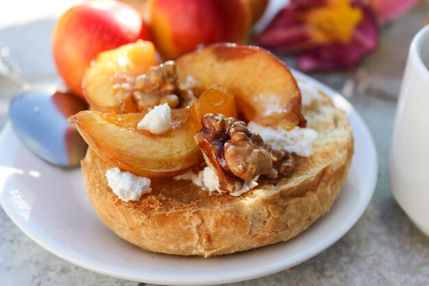 Al fresco Breakfast of grilled bread rolls with goat fat, fruit, nuts, orange juice and coffee