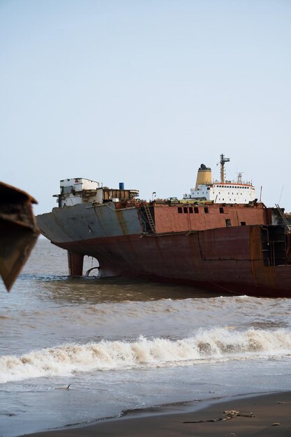 Photo alang bhavnagar 31 august 2024 a crane lifts a large ship at alang shipyard emphasizing industrial