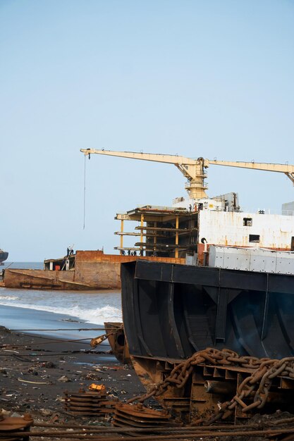 Photo alang bhavnagar 31 august 2024 a disused vessel is found the shoreline of alang shipyard reflecting