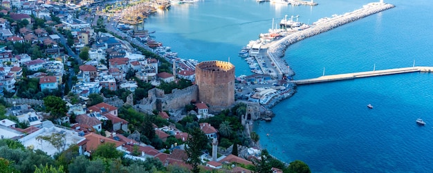 Alanya at sunset with a view into old port Red tower