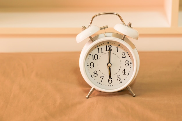 Alarm clock on the bed