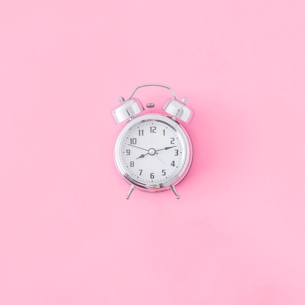 Photo alarm clock on pink background