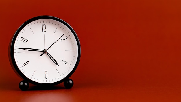 Alarm clock on red background time concept