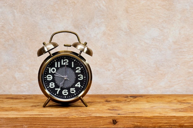 Alarm clock showing seven oclock on wood table