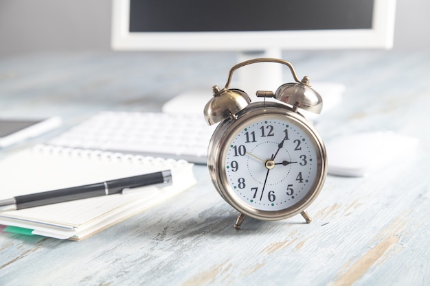 Alarm clock with business object on the desk.