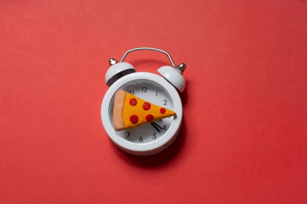 Alarm clock with a piece of pizza Pizza time Snack time