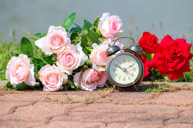 Photo alarm clock with roses on footpath