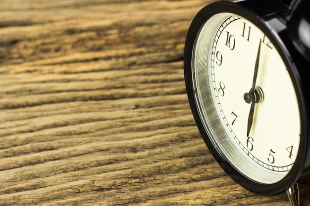 Alarm clock on wooden background